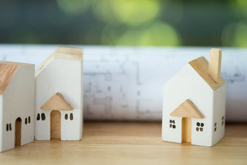 Miniature wood home and with architecture plan background