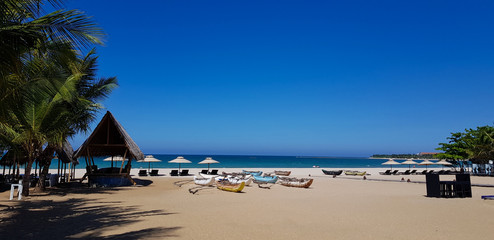 beach with chairs and umbrellas in passikuda Sri lanka