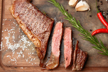 steak from beef, steak with vegetables, proper nutrition, healthy food,  a piece of boiled pork on a wooden board, presentation and serving, rustic style, vegetables for meat, 