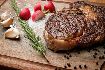steak from beef, steak with vegetables, proper nutrition, healthy food,  a piece of boiled pork on a wooden board, presentation and serving, rustic style, vegetables for meat, 