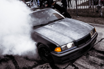 Moldova 25.09.2019. Sport modern Stance Car racing car drifting with smoke drift burnout, big colourful green blue clouds with clean wheels and burning tires . Extreme street stunts. - obrazy, fototapety, plakaty