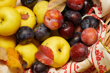 Fruits and vegetables with pumpkins, apples, corn, nuts, mushrooms, berries - autumn harvest and healthy food concept. Yellow leaves. Still life on wooden background.