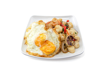 Rice Served with Stir Fried Holy Basil with Squid isolated on white background with clipping path, Fried eggs on rice.