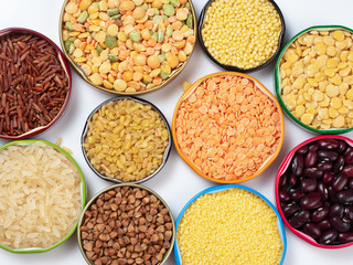 Top view of cereals and grains in bowls on white background