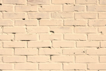 Brick wall of beige painted brick close up