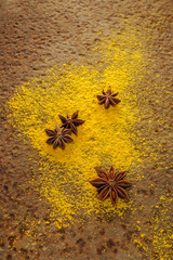 Curry and anise powder on an old, rusty, metal background. Spices. View from above.