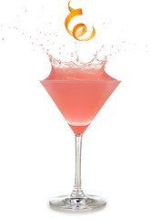 orange rind falling into a splashing pink cocktail isolated on white