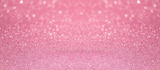 beautiful pink sequins on the glitter sparkle of sun light background with blur bright bokeh