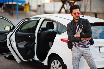 Fototapeta premium South asian man or indian male wear red eyeglasses stand near his white transportation on car wash.