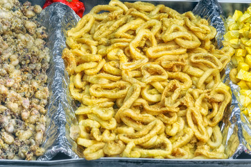 Calamari rings, cooked at portable restaurant, ready to eat at the street. Famous food in Madrid and others towns in Spain when there are festivals and fairs. Intense color.