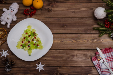 Edible Christmas tree made of vegetables with copy space for the festive New Year and Christmas table. Idea for decorating holiday dishes. How nice to serve vegetables and salad.