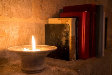 A candle with books