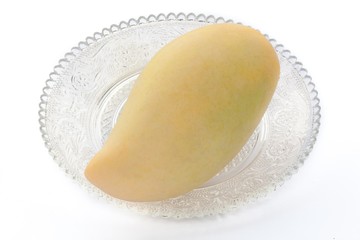 Yellow mango in a glass plate white background