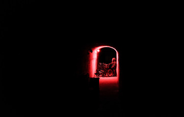 A man in a protective suit in a bunker carries a wheelchair. Bunker radiation protection.