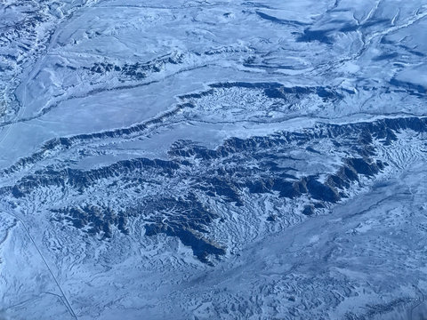 Flight Over A Snow Covered Desert Landscape 