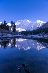 Portrait view of the  Reflection of Fairy meadows during the sunset period with  Nanga parbat mountain range