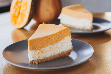 Piece of pumpkin homemade cake. Festive dessert concept. pumpkin tart on cozy cafe background, selective focus, noise effect