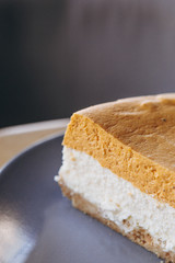 Piece of pumpkin homemade cake. Festive dessert concept. pumpkin tart on cozy cafe background, selective focus, noise effect