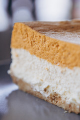 Piece of pumpkin homemade cake. Festive dessert concept. pumpkin tart on cozy cafe background, selective focus, noise effect