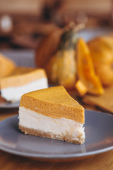 Slices of Freshly Baked Pumpkin Pie on cozy cafe background, selective focus, noise effect