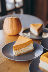 Piece of pumpkin homemade cake. Festive dessert concept. pumpkin tart on cozy cafe background, selective focus, noise effect
