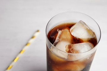 Refreshing soda drink with ice cubes on white background, closeup. Space for text