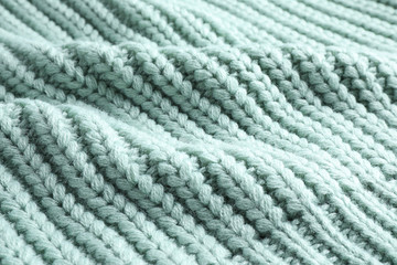 Warm knitted sweater as background, closeup view