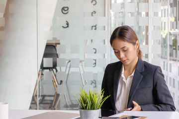 Businesswoman compare finance data on table.