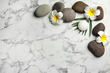 Flat lay composition with stones on white marble background, space for text. Zen concept