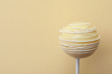 Sweet cake pop on yellow background, space for text