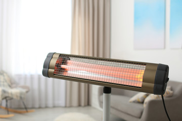 Modern electric infrared heater at home, closeup