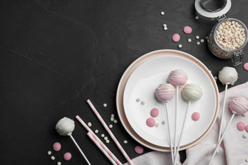 Sweet cake pops on black background, flat lay. Space for text