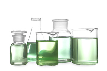 Glassware with liquids isolated on white. Laboratory analysis