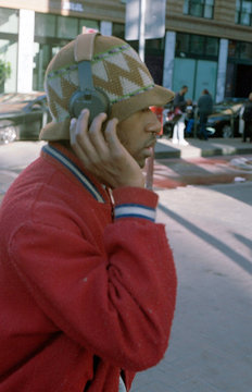 Profile of young man wearing headphones over hat