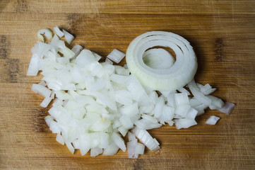 White onion on a wooden board. vegetable slicing process. cooking food