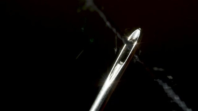 Threading through the eye of a needle in macro