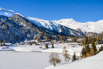 Fototapeta na wymiar Landscape of lake Davos, covered by ice, in winter resort Davos, Switzerland.
