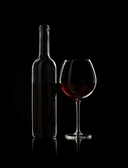 bottle and wine glass with red wine