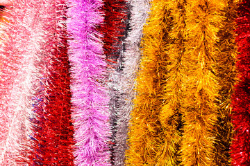 Festive Christmas decoration of colorful tinsel for the Christmas tree and house