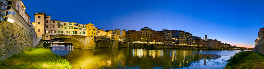 Old Bridge and Florence Lungarni at night. Panoramic cityscape in Autumn, Tuscany - Italy