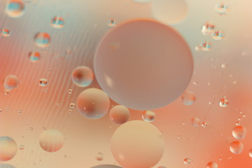 Pink background Oil in Water surface Foam of Soap with Bubbles macro shot close-up