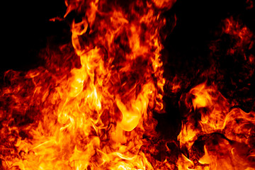 Fire flame burning fuel glowing on black night background