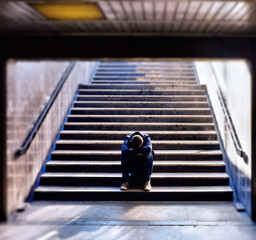 Lonely man sitting on the stairs - 299608034