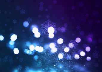 Winter abstract, blurred background with bokeh. Blurry night city lights in reflection on a snowy road. Neon light, falling snow, snowflakes.