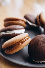 Close up Traditional chocolate and Pumpkin Whoopie pies made with vanilla cream cheese. Background for bakeries, cafes, restaurants