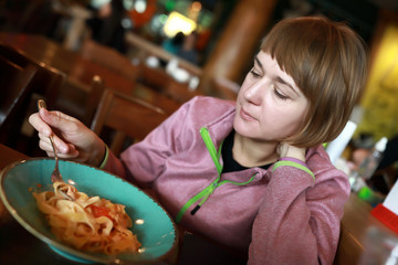 Woman eating fettuccine