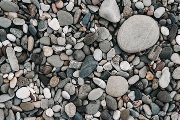 Gravel pattern of colored stones. Abstract nature pebbles background. Stone background. Sea peblles beach. Top view.