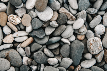 Gravel pattern of colored stones. Abstract nature pebbles background. Stone background. Sea peblles beach. Top view.