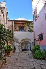 Fototapeta na wymiar Venosa, Italy, 10/27/2019. A narrow street among the old houses of a medieval village