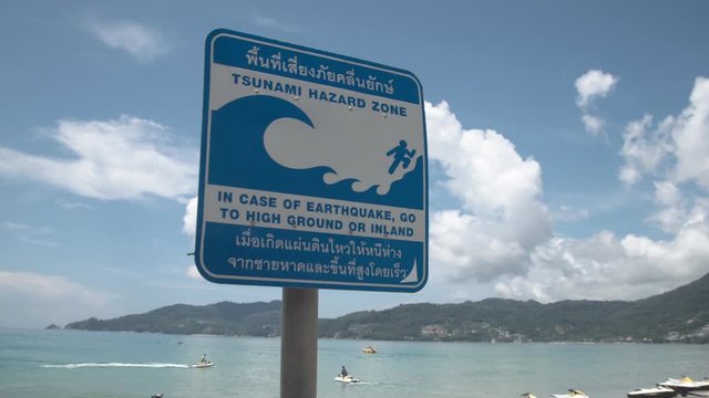 Tsunami warning sign on street at Patong beach in Phuket, Thailand. 